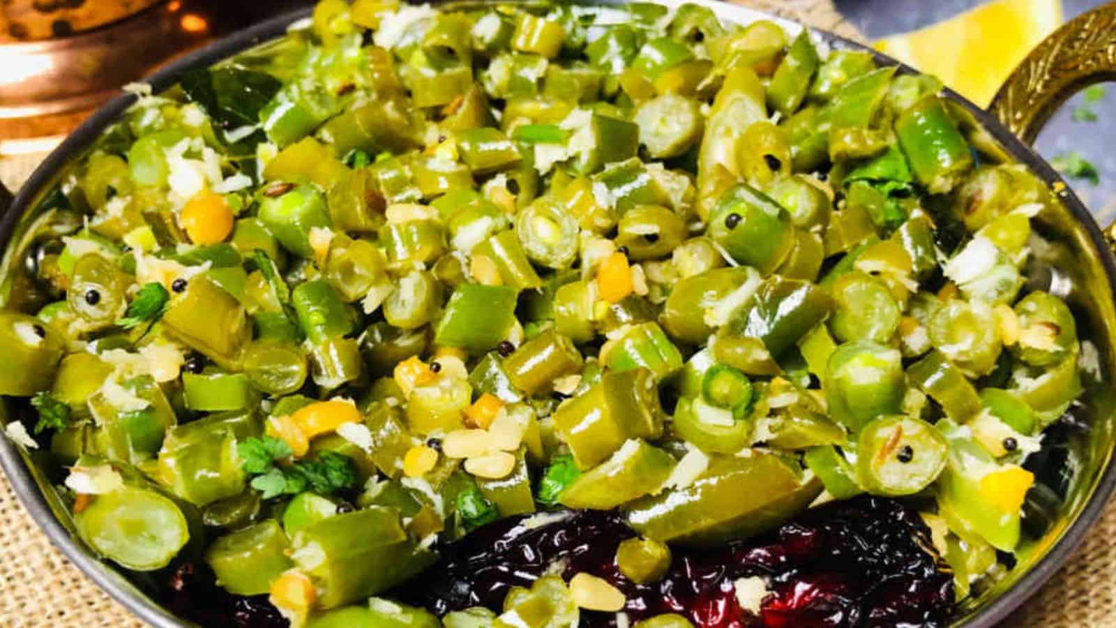 A bowl of chopped Beans Palya mixed with spices, served on a dining table.