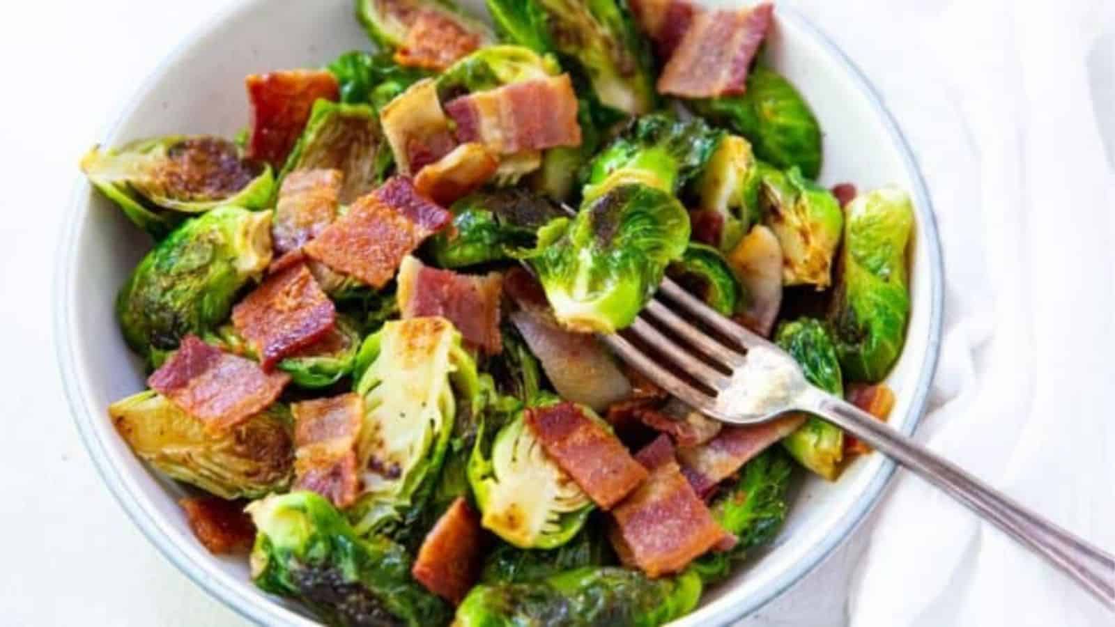 Blackstone Brussel Spouts with bacon in a white bowl with a fork.