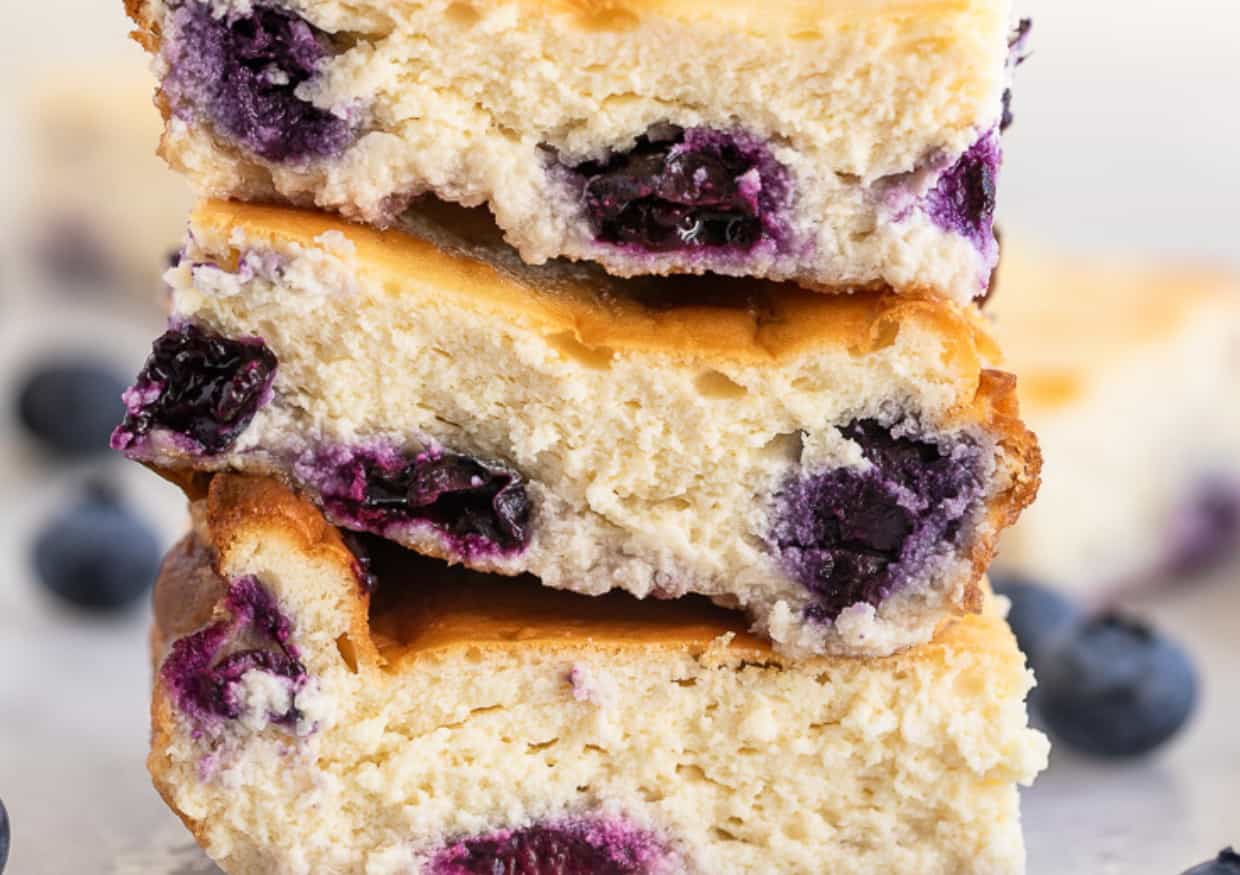 A stack of blueberry cheesecake bars.