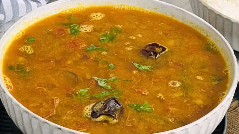 A bowl of Mysore Rasam, served alongside rice.