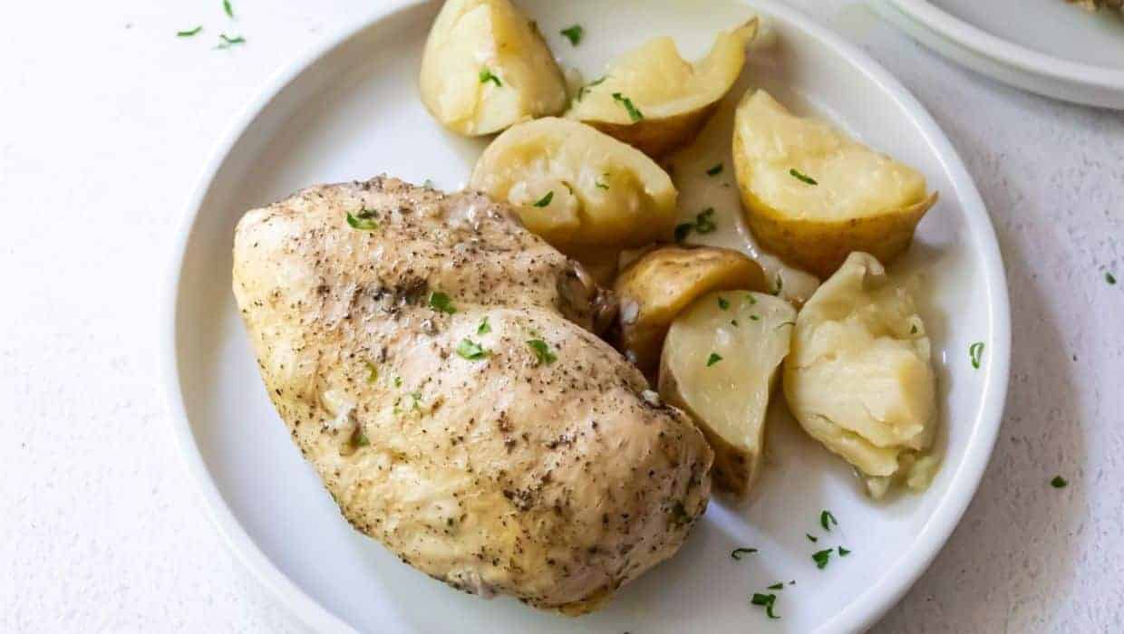 Instant Pot Chicken and potatoes with parsley on a white plate.