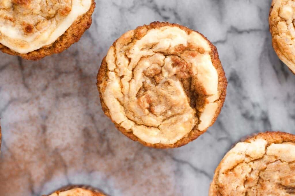 Overhead view of freshly baked muffins on a marble countertop.