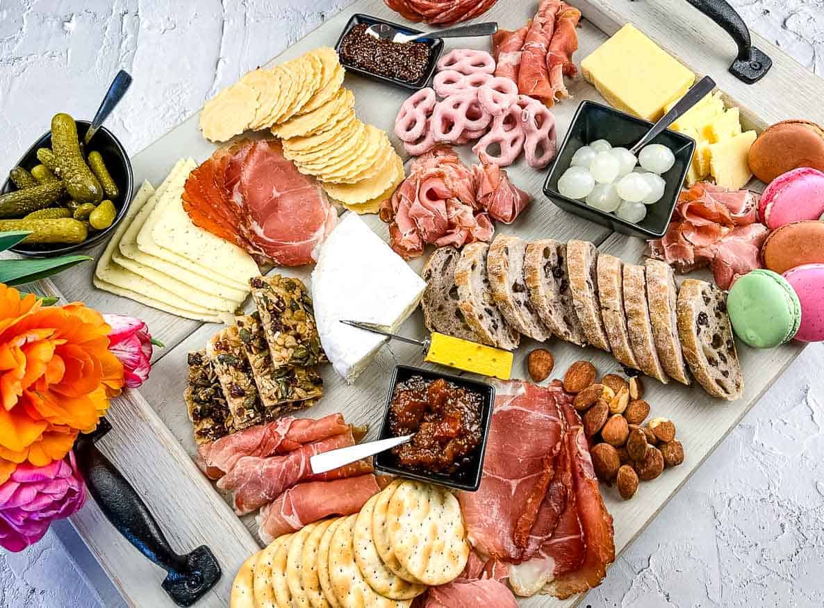 A mother's day charcuterie board with assorted meats and cheeses.