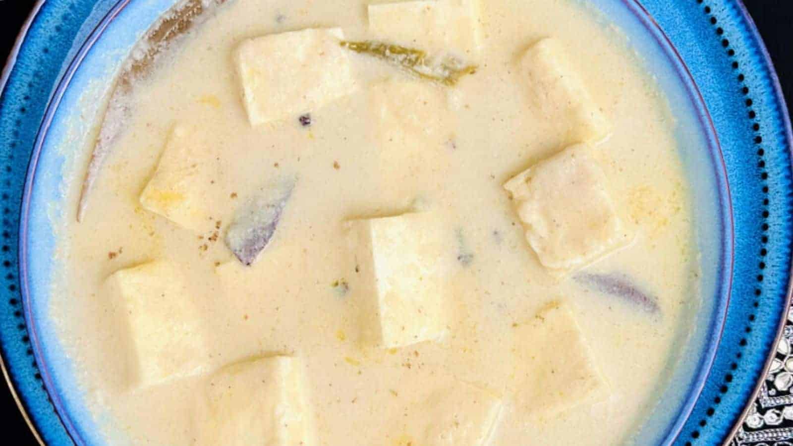 A bowl of Shahi Paneer Instant Pot, served in a blue-rimmed bowl.