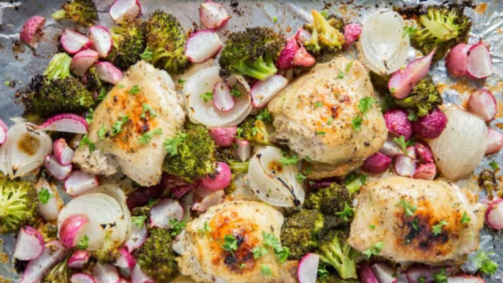 Sheet Pan Chicken and Vegetables on a sheet pan with foil, broccoli, onions, radishes, and parsley.