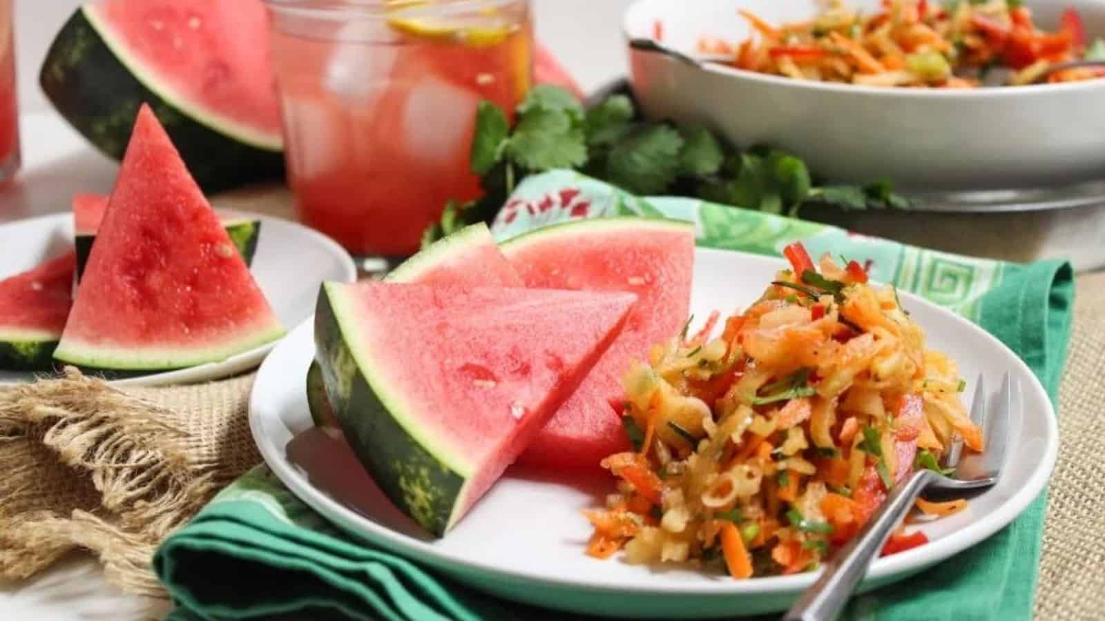 A plate with sliced watermelon next to watermelon rind coleslaw.