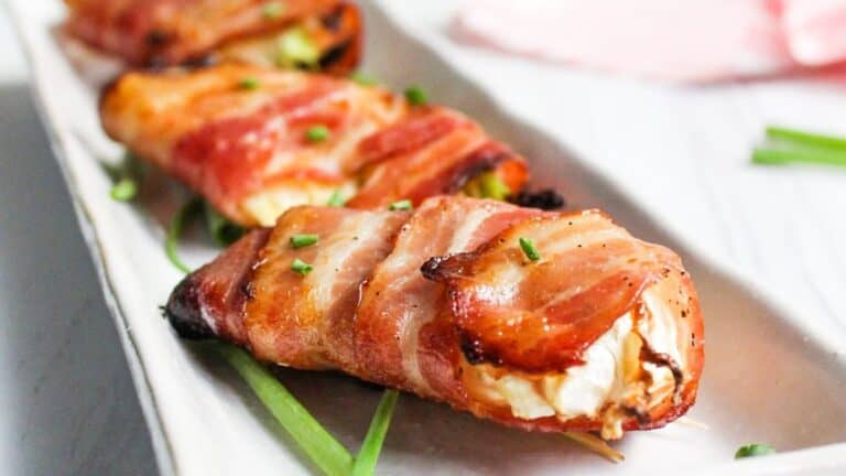 Bacon wrapped air fryer cabbage on white plate.