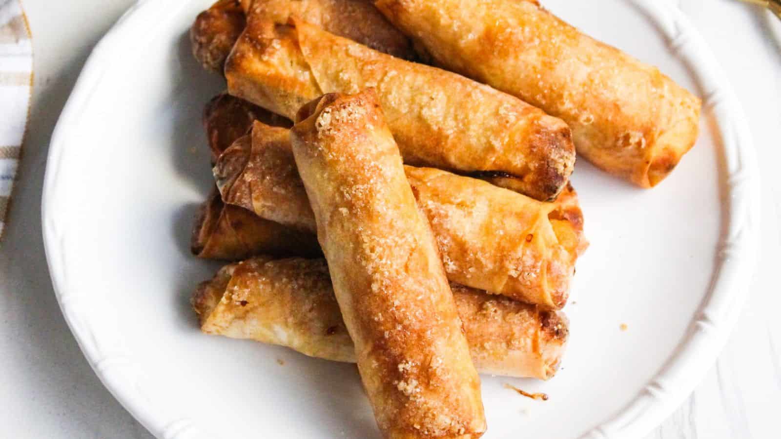 A plate of freshly cooked Filipino banana turon lumpia spring rolls.