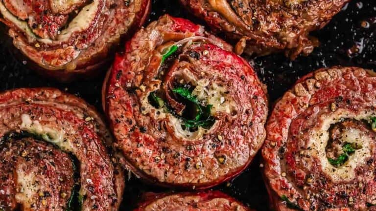 Grilled tomato slices topped with herbs and spices.