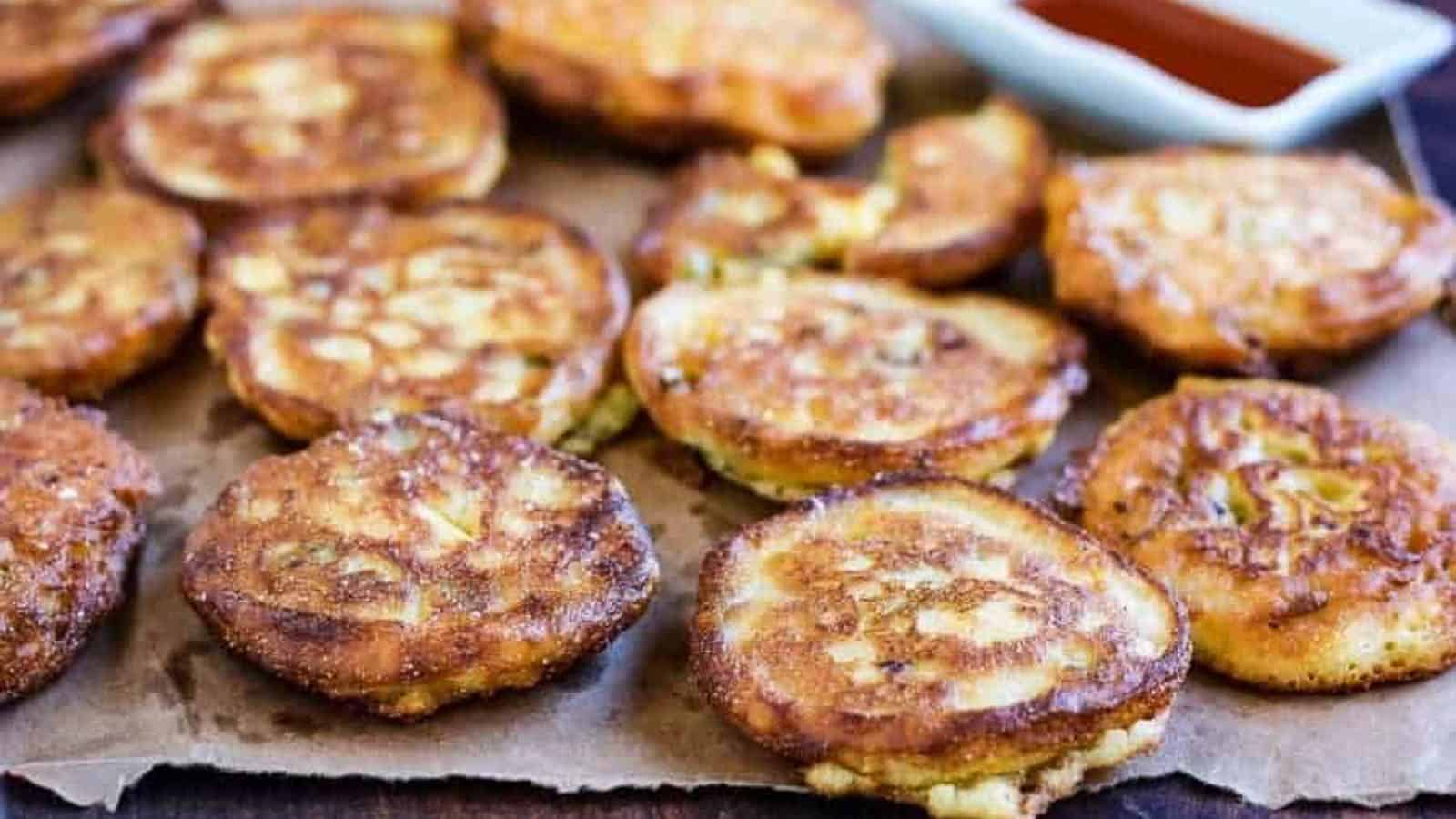 Fried green tomato fritters on a sheet of parchment.