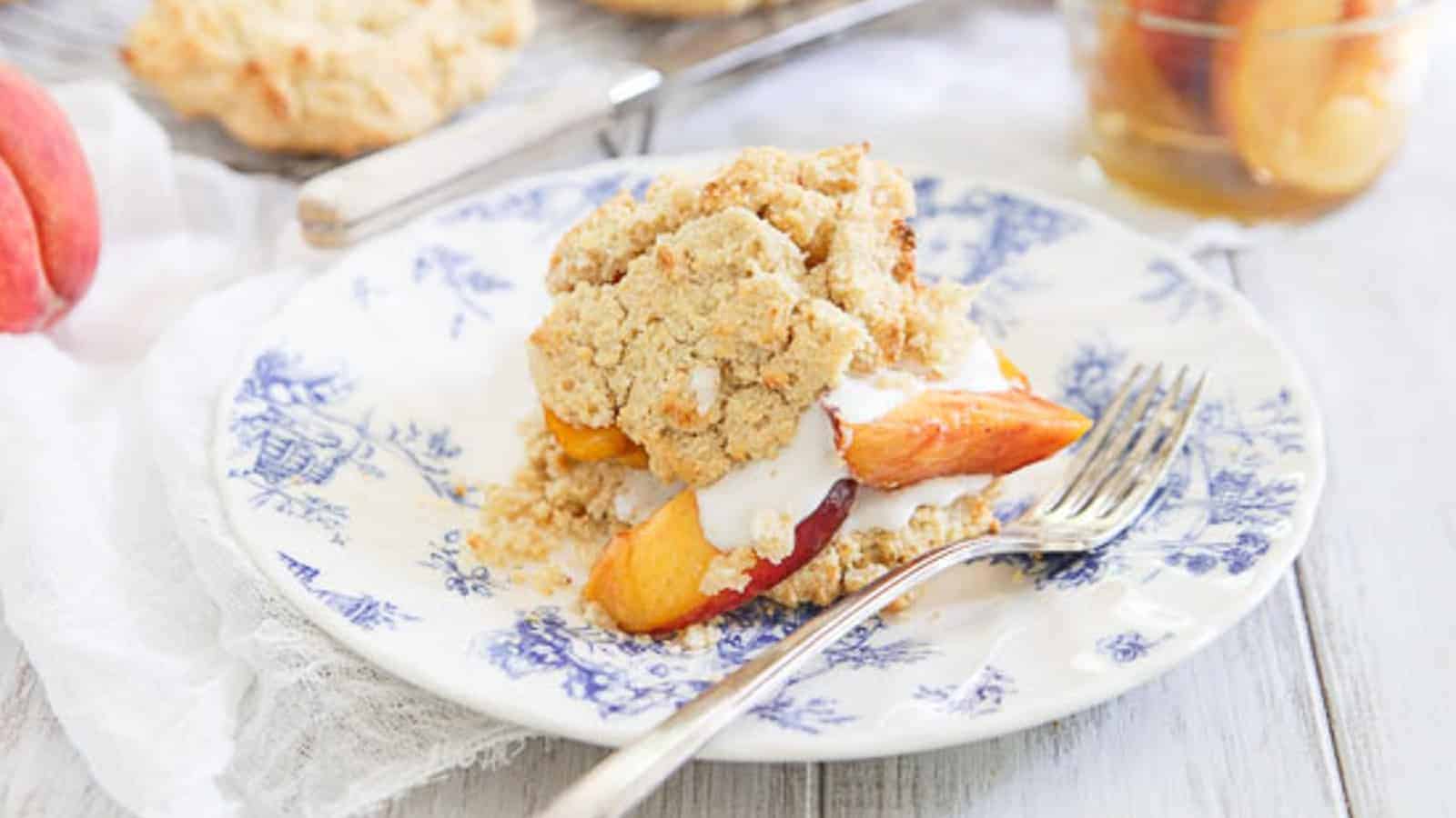 Peach shortcake on a blue and white plate with a fork.