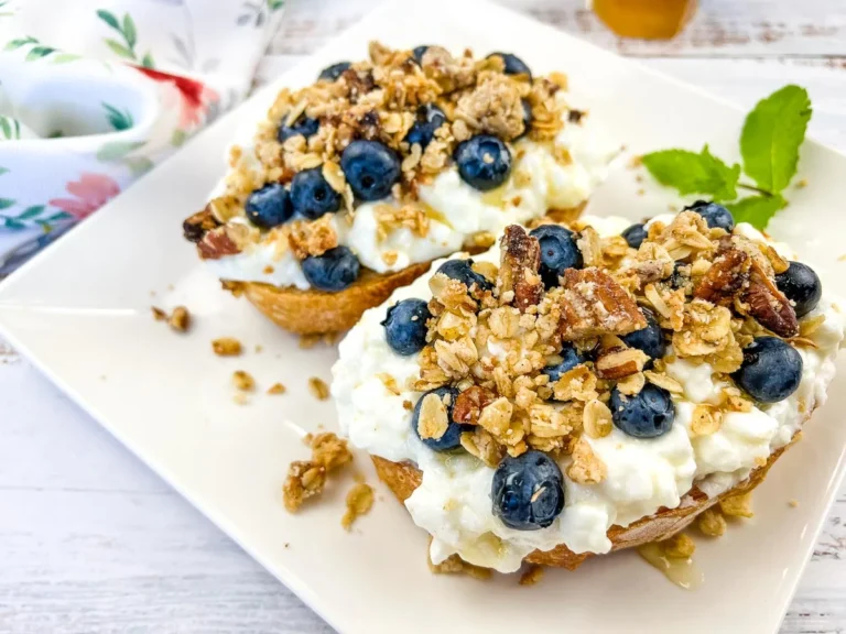 A plate of cottage cheese toast with blueberries.