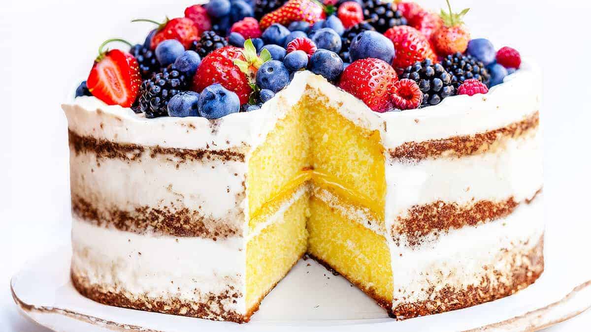 Lemon Curd Cake with a slice removed showing the inside of the cake.