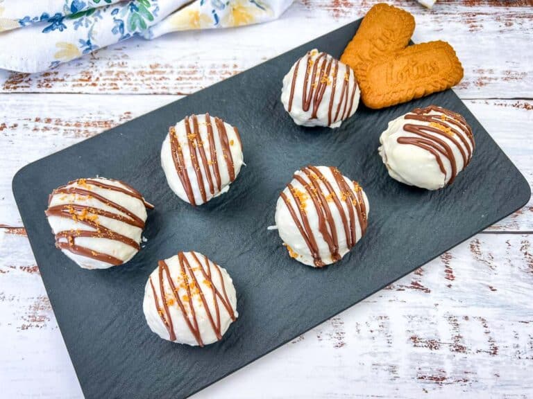 Six Cookie Butter Cake Balls on a slate tray.