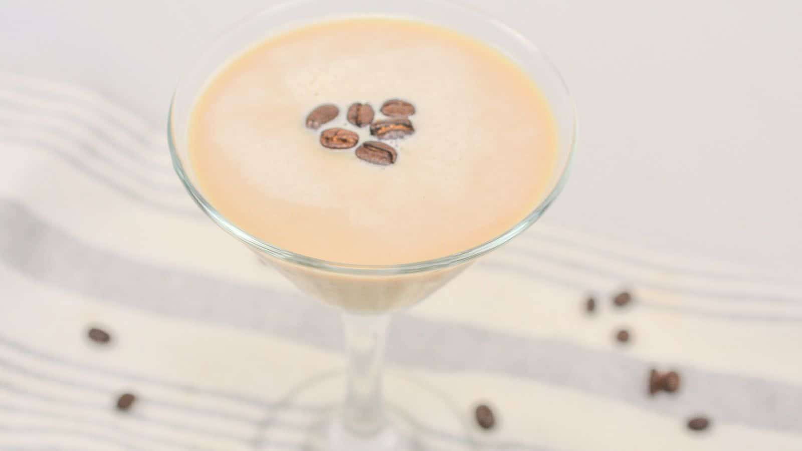 A refreshing glass of espresso martini with rich coffee beans.