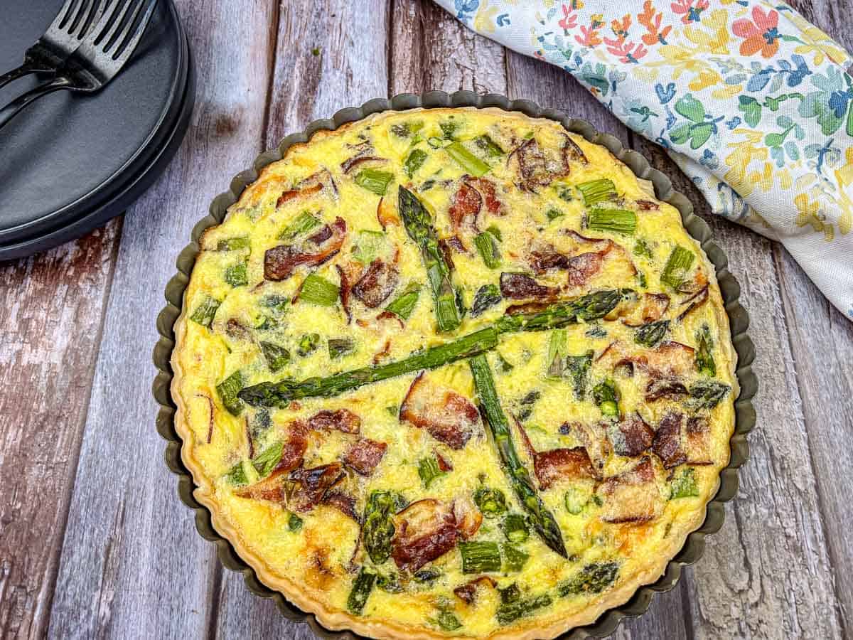 Asparagus & Ricotta Quiche served on a pie dish.