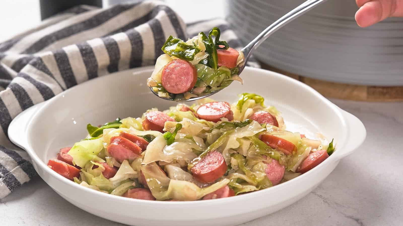 Cast iron bowl with cabbage and sausage.