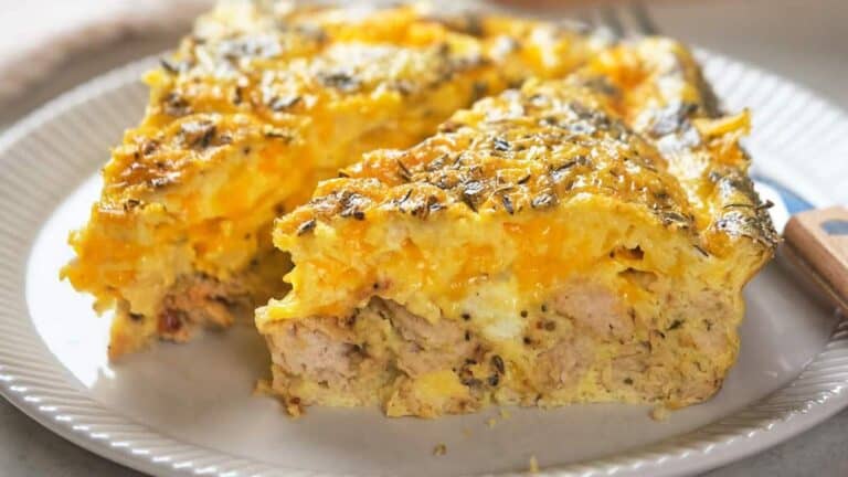 A close-up of two slices of a savory breakfast casserole.