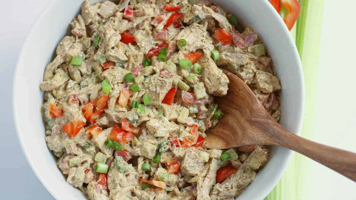 Chicken salad sandwich on a white plate.