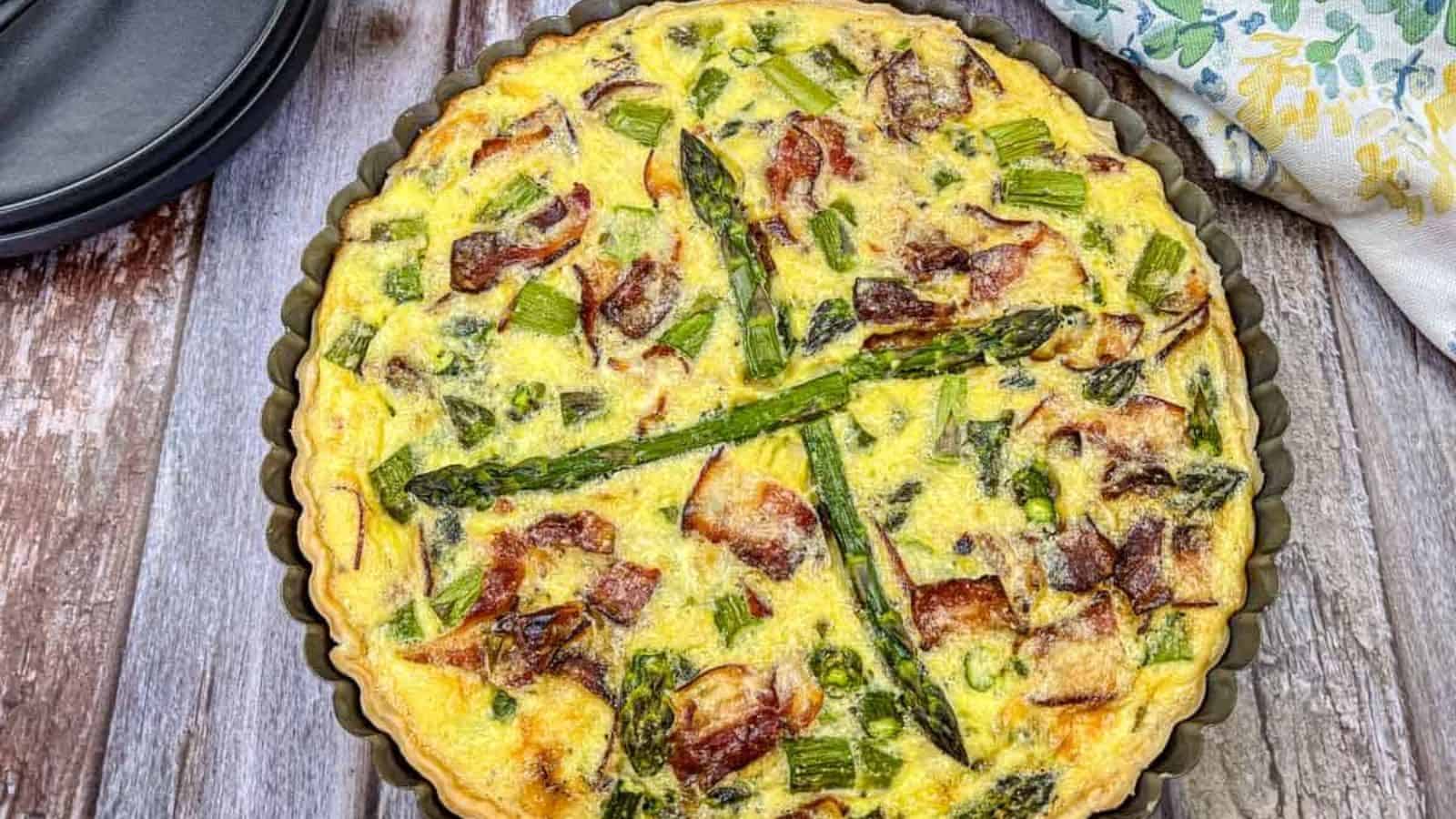 Asparagus & Ricotta Quiche served on a pie dish.
