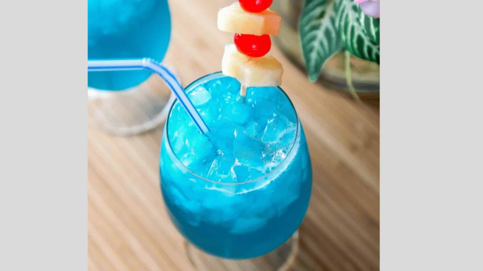 A blue hawaii cocktail garnish with pineapple and marachino cherries.