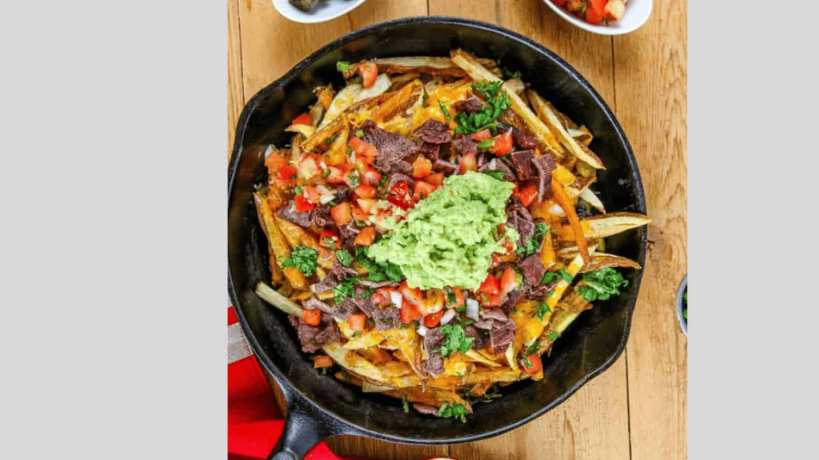 French fries topped with steak, cheese, guacamole, and pico de gallo.