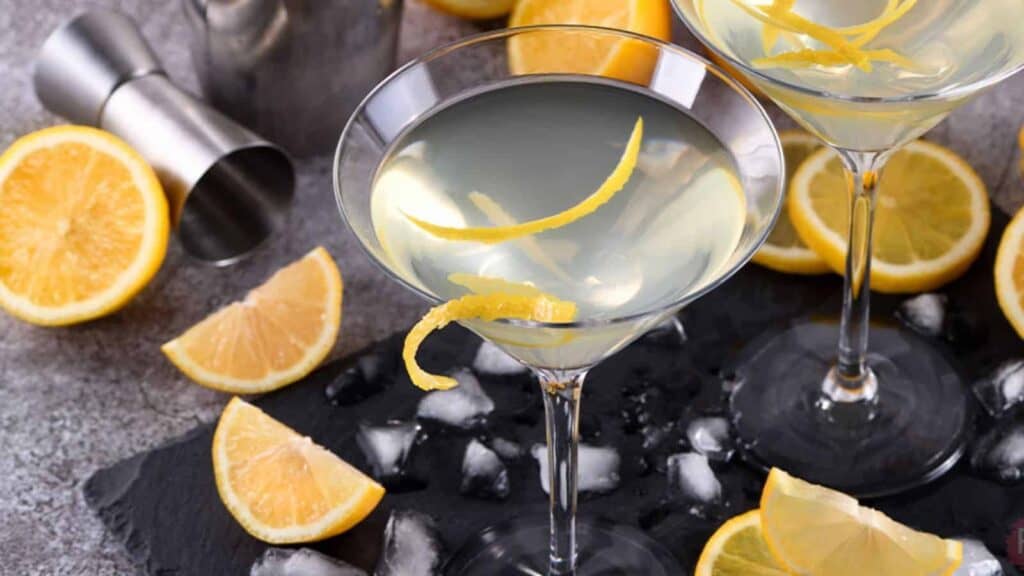 Two martini glasses filled with a lemon drop martini.