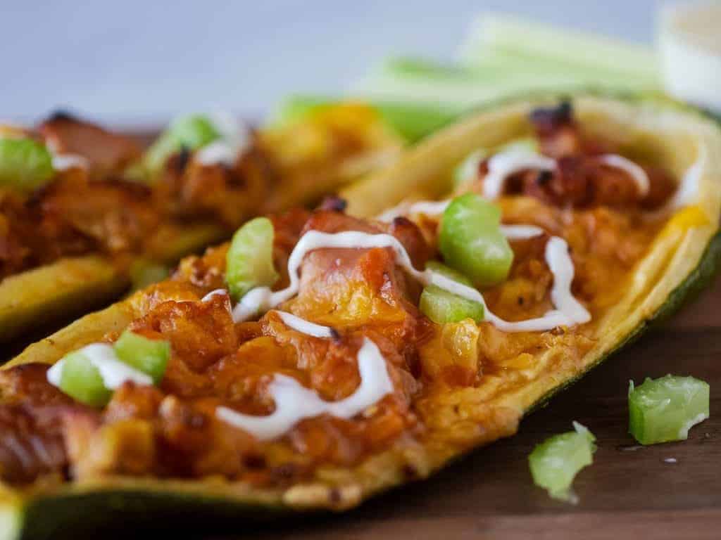 Closeup of zucchini boat stuffed with Buffalo chicken filling