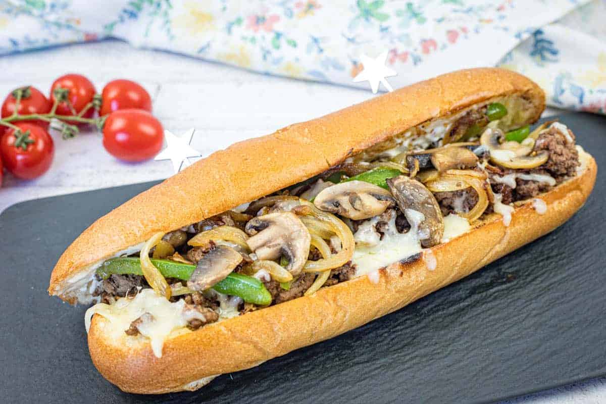 Ground Beef Philly Cheesesteak on a black slate plate.